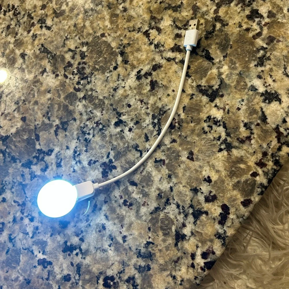 White Mini phone light with clip and  Charging Cable